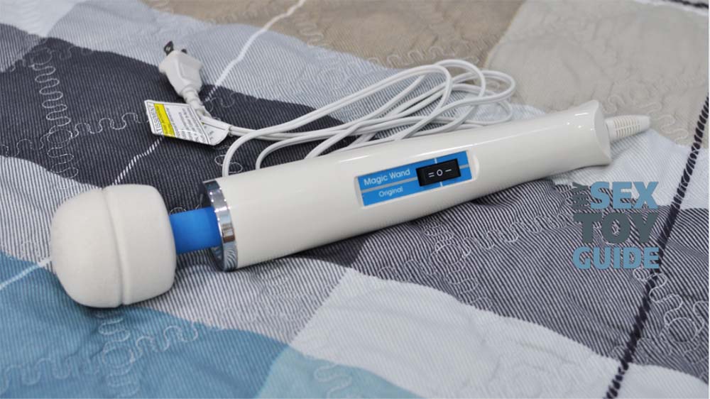 The Hitachi Magic Wand laying on a bed