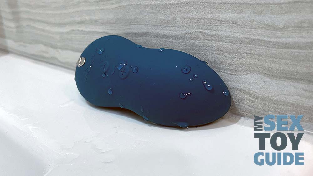 A wet We-Vibe Touch X laying on a bathtub