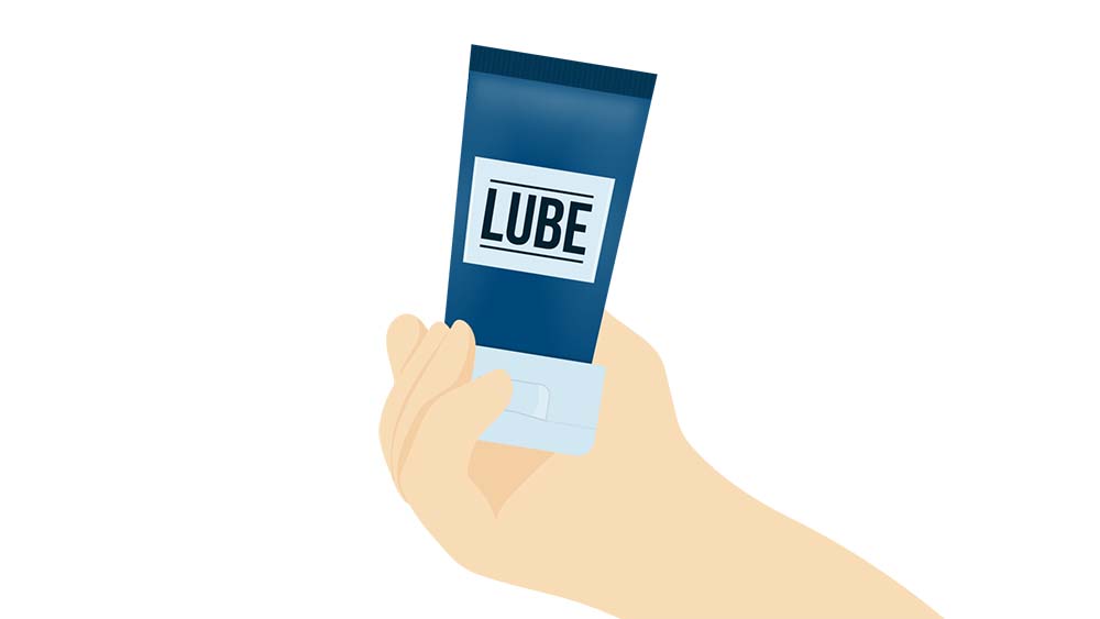 A man holding a lube bottle