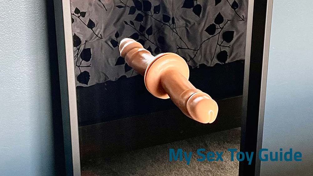 A suction cup dildo attached to a mirror