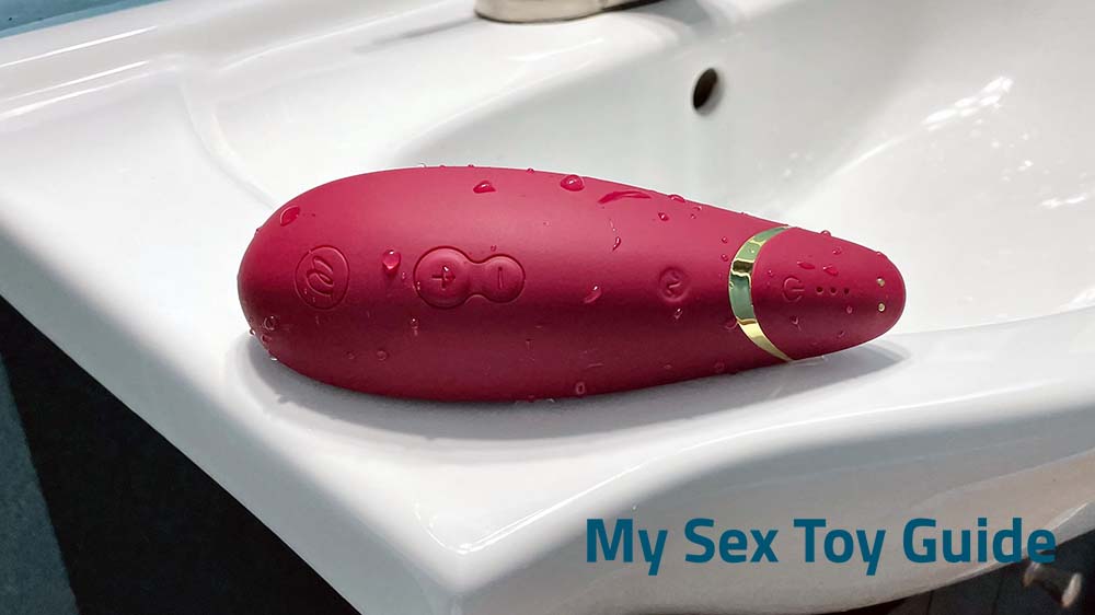A wet Womanizer Premium 2 lying on a sink