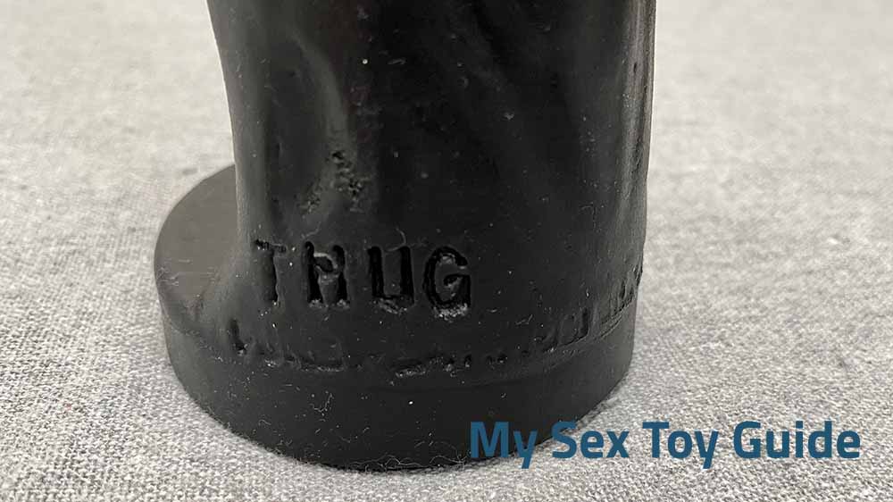 Closeup of the "Thug" logo on the base