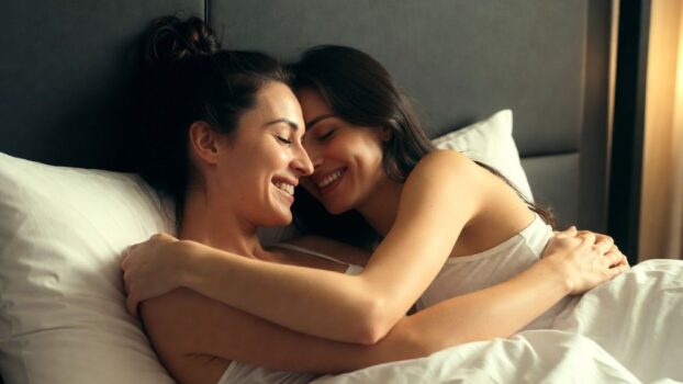 Two women hugging in bed