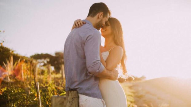 A young couple hugging outside