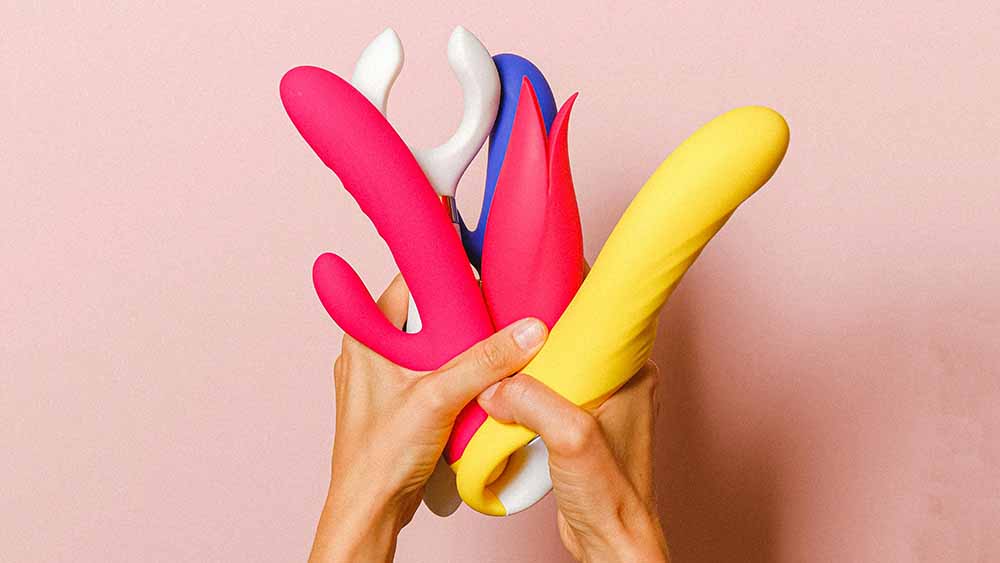 A woman holding sex toys