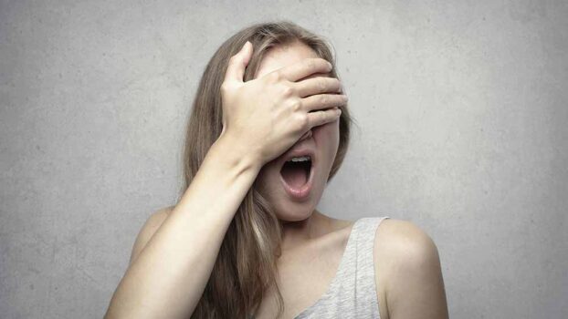 A woman covering her face