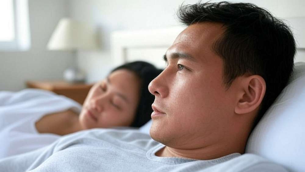 A man lying in bed thinking