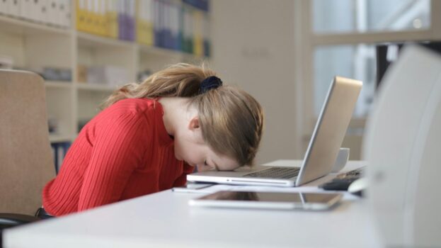 Woman leaning over laptop