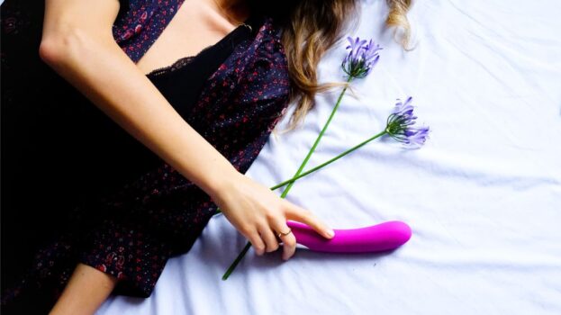 A woman with a vibrator in bed