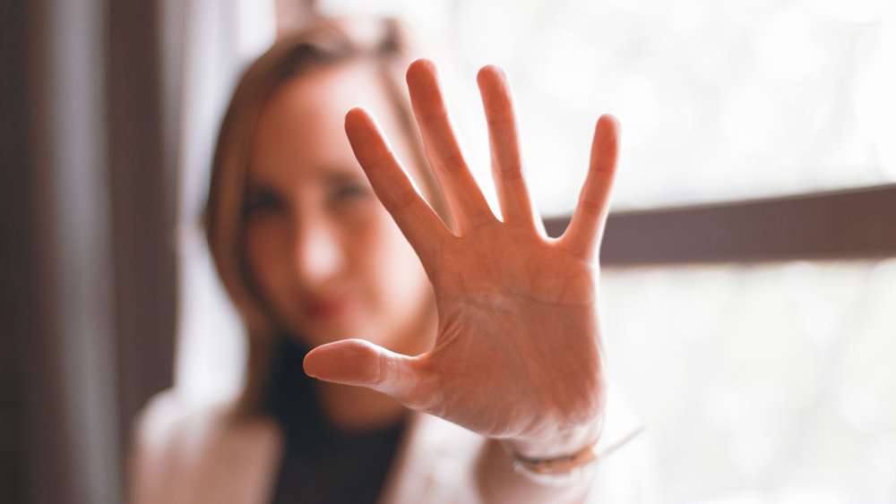 A woman holding up her hand in a stop sign